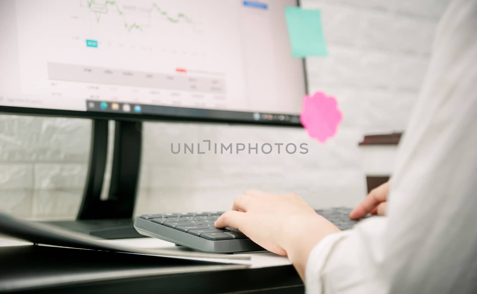 The hand of a businesswoman is working with a computer