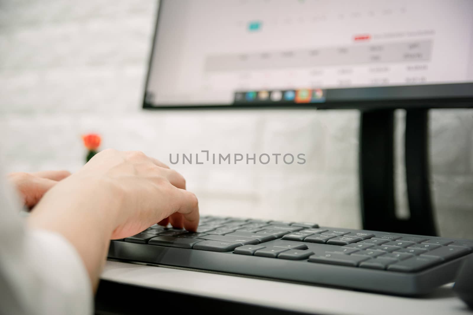 The hand of a businesswoman is working with a computer by sompongtom