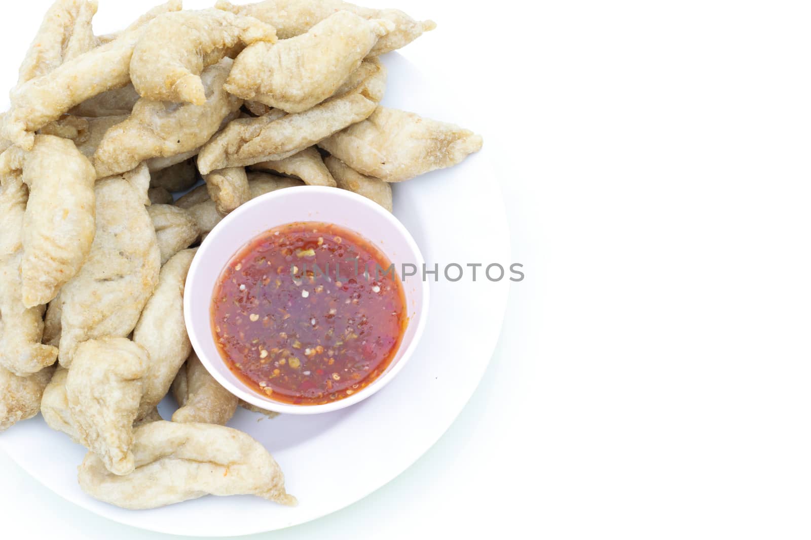 Fried meatballs and dipping sauce on white background