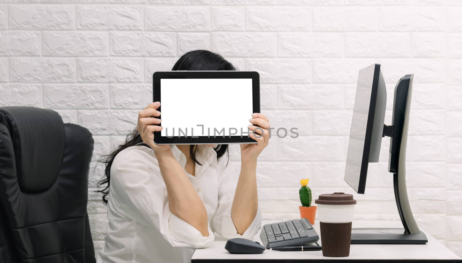 A woman with a tablet show on the desk