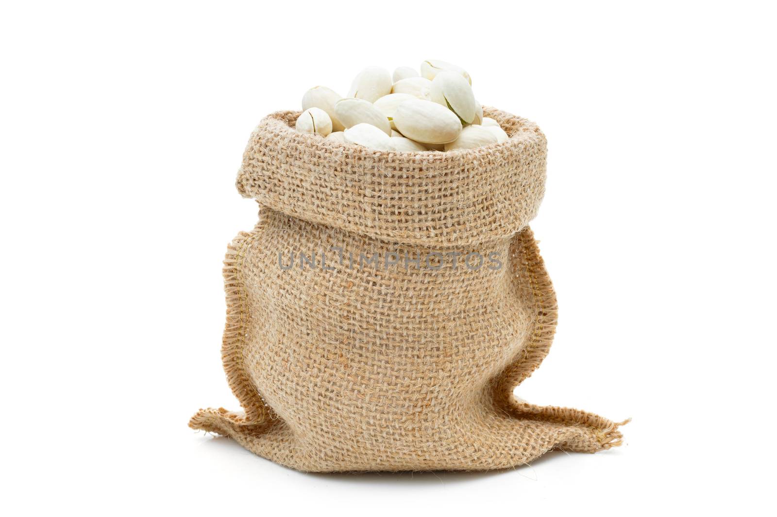 Pistachio in a sack on a white background by sompongtom