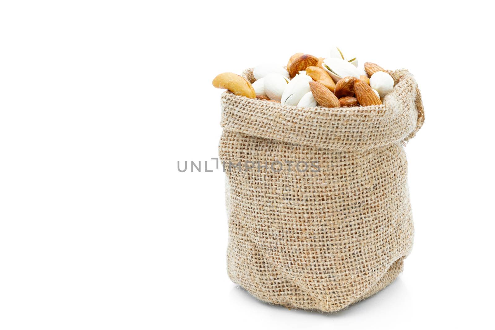 Almonds Pistachio and  Cashews in a sack on a white background