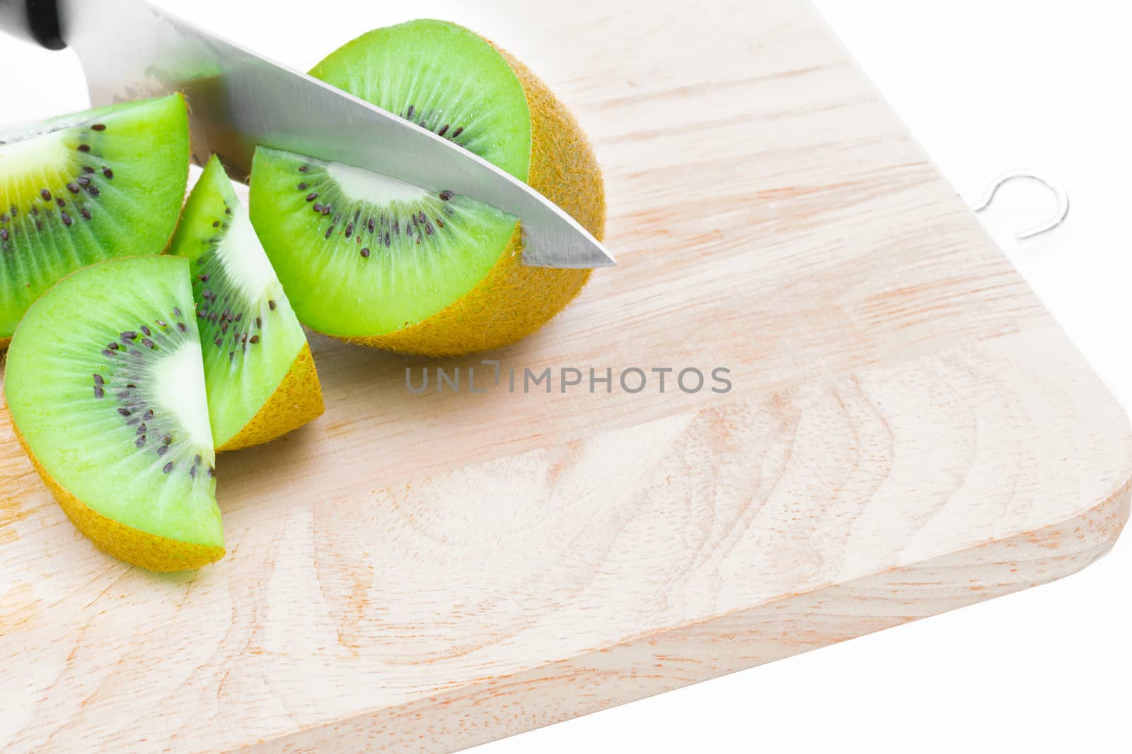 A knife kiwi fruit on a white background