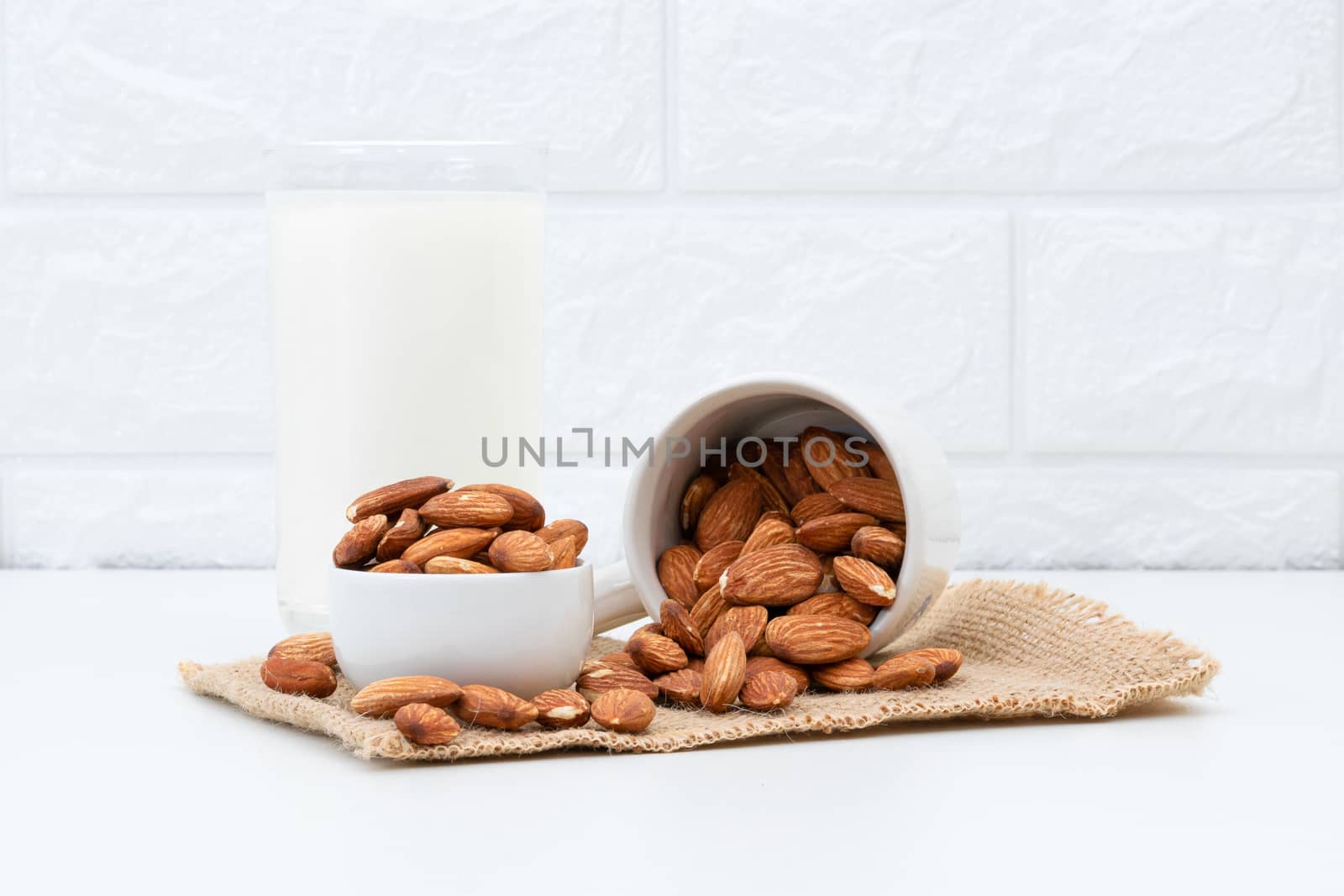 Milk Almonds in a glass on a white background by sompongtom