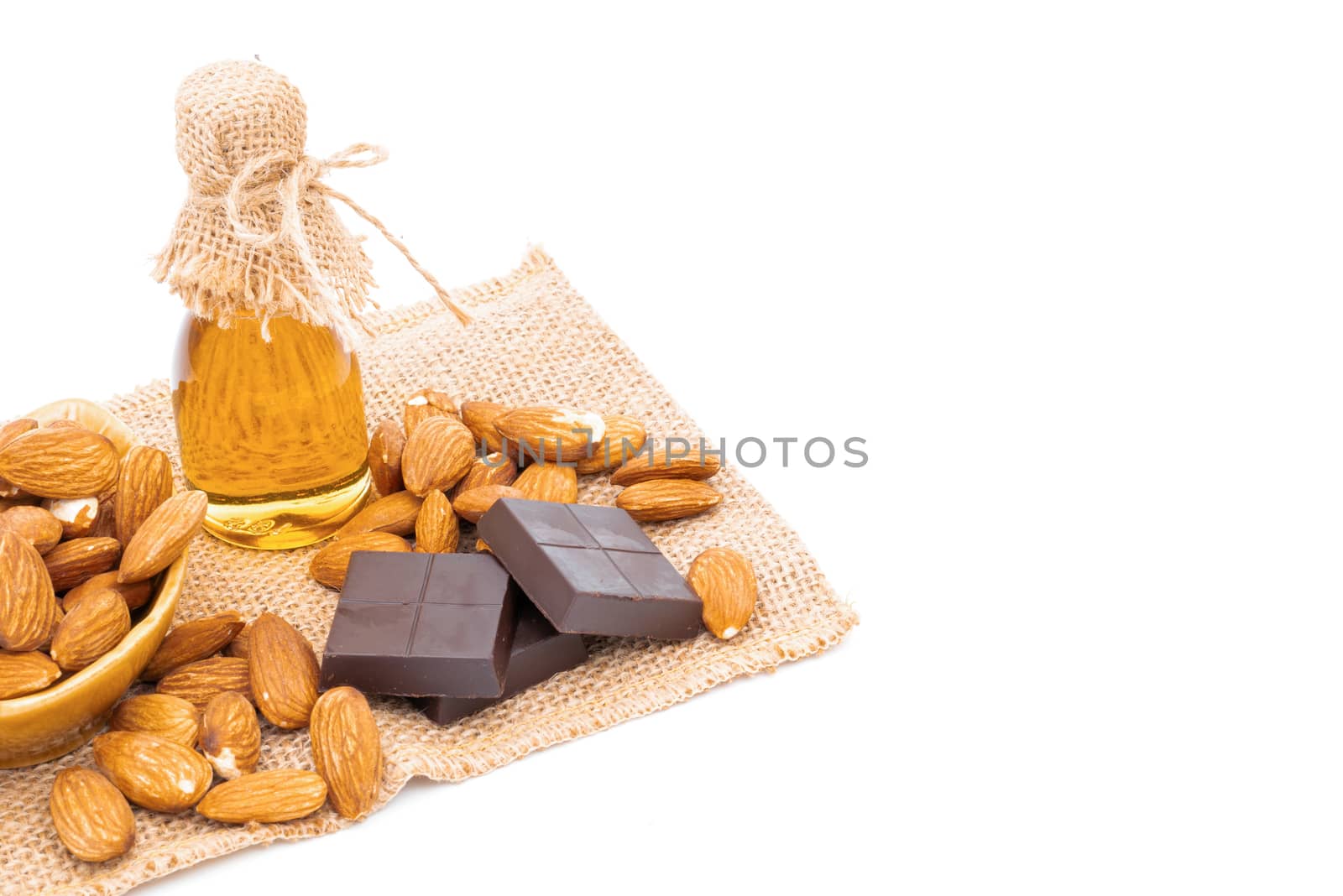 Honey jar chocolate and almonds on a white background by sompongtom