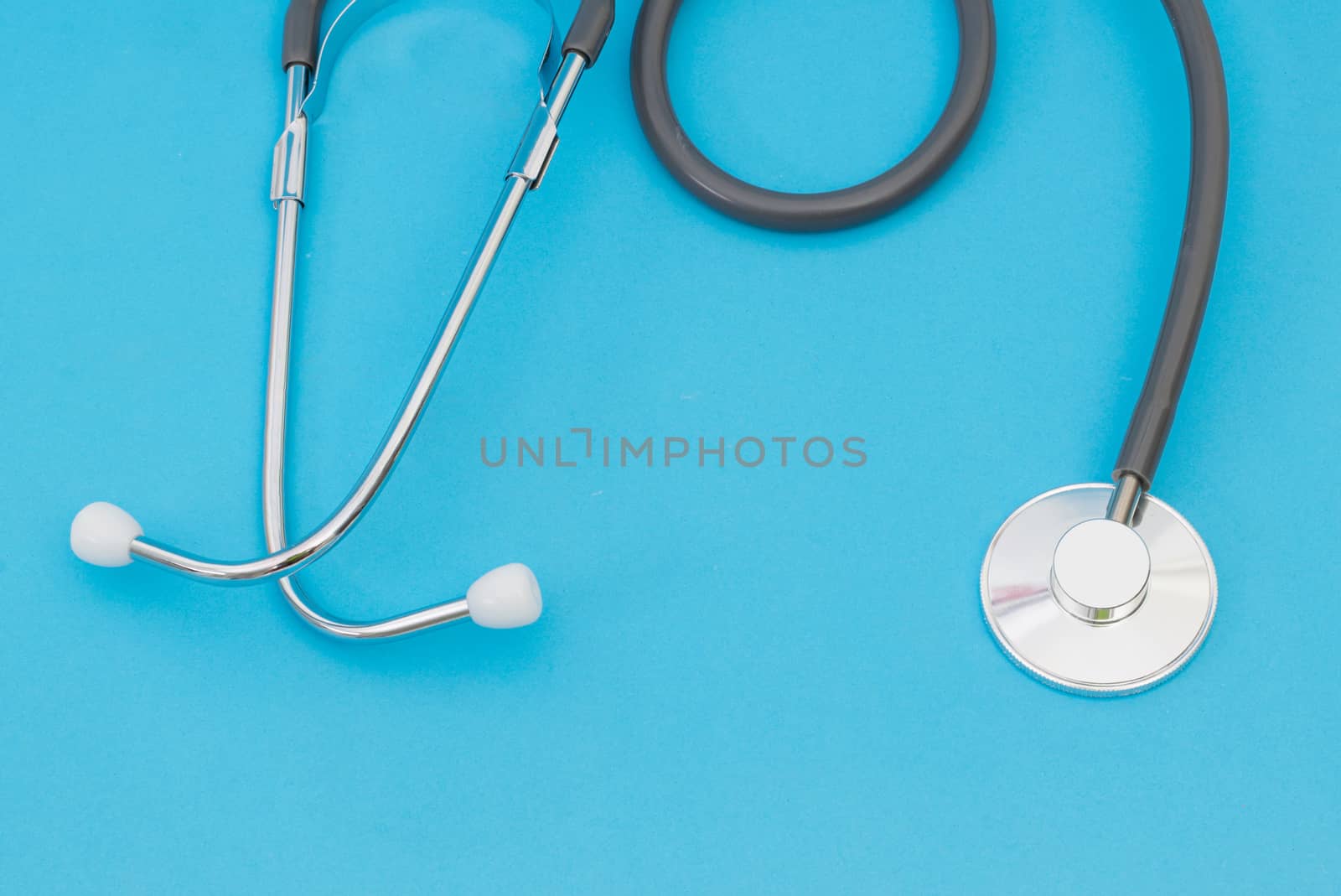 Medical stethoscope on a blue background by sompongtom