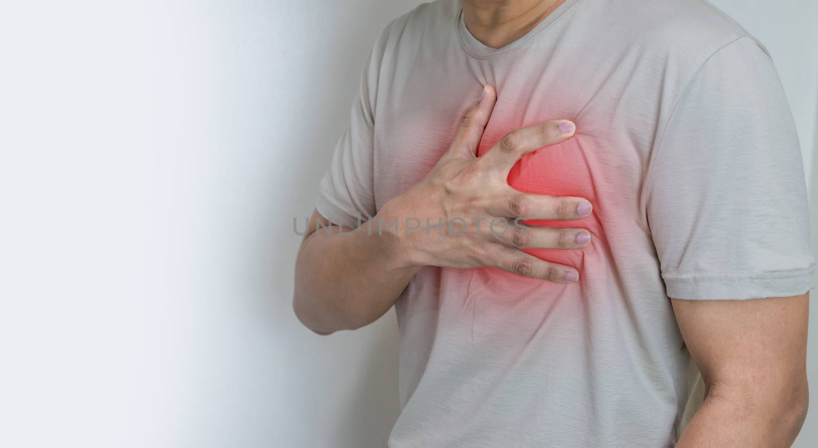Hands holding chest with symptom heart attack disease by sompongtom