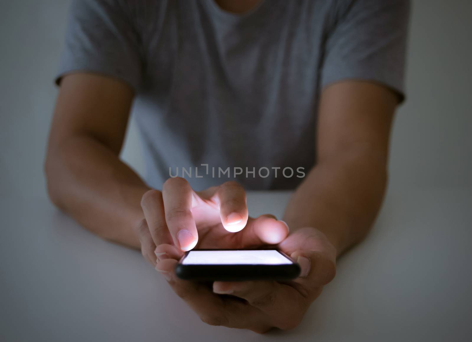 A man with a smartphone social and a touch screen monitor by sompongtom