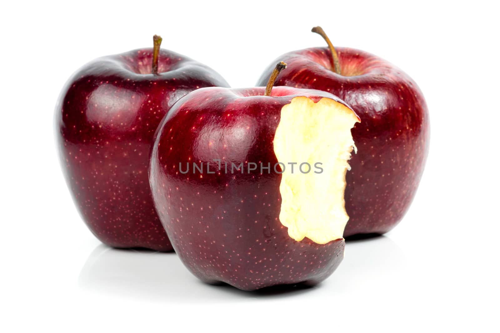 Fresh red apple nibble on a white background by sompongtom