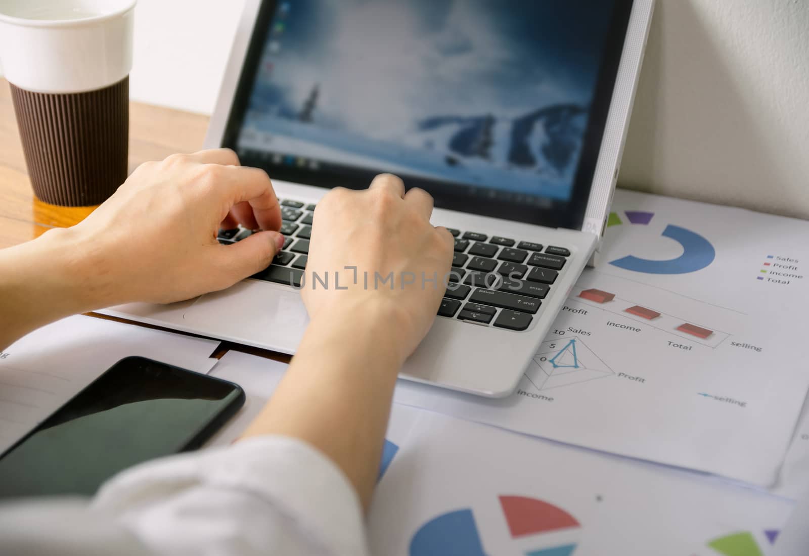 Business hand to computer Human work in the office on the desk