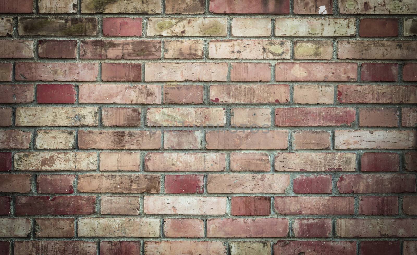 Red vintage brick wall with grungy structure. Horizontal wide background. Distressed wall with broken bricks texture. Retro house facade.