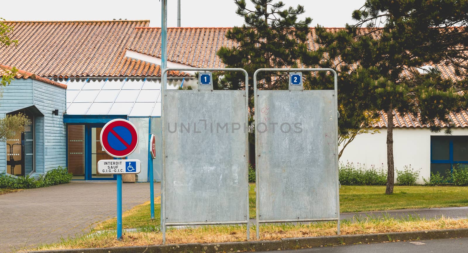 Bretignolles sur Mer, France - April 25, 2016 : During the presidential election in France in front of a polling station, one installs campaign billboard or will be posted posters of the candidates