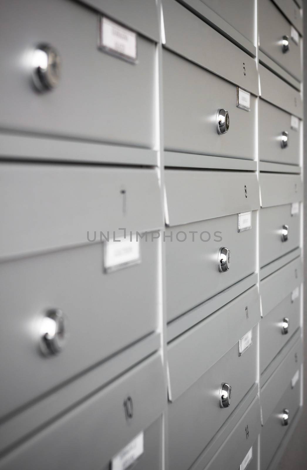 Rows of aluminum mail boxes for concepts such as safety and security, business communication and concepts. Shallow depth of field.