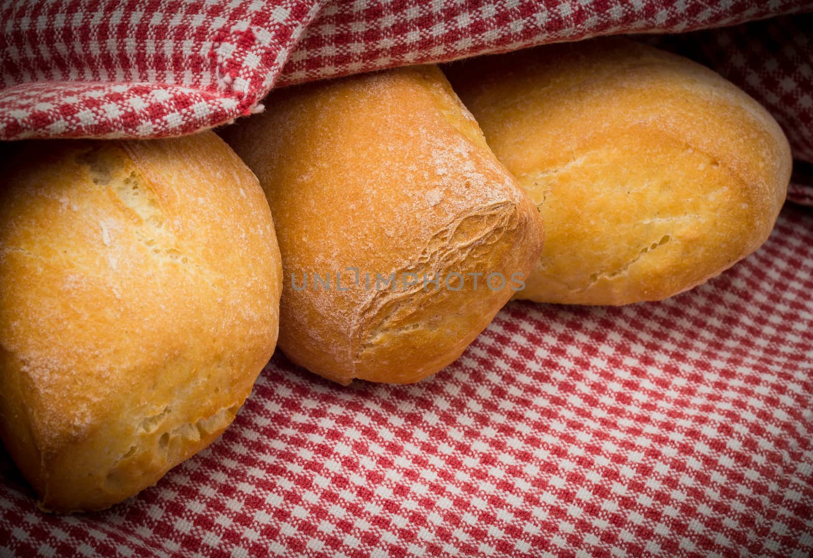 Fresh bread with red tablecloth. Shallow depth of field.