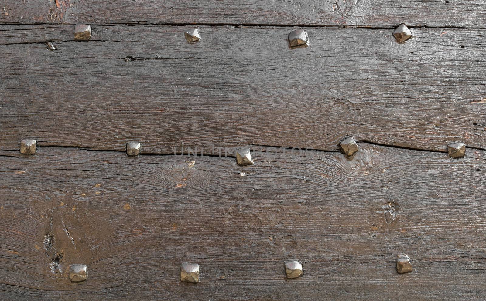 Wooden background with old nails