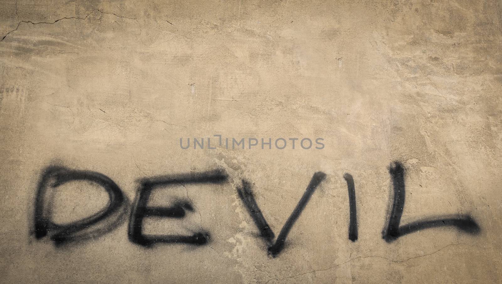 The word "devil" on grungy wall