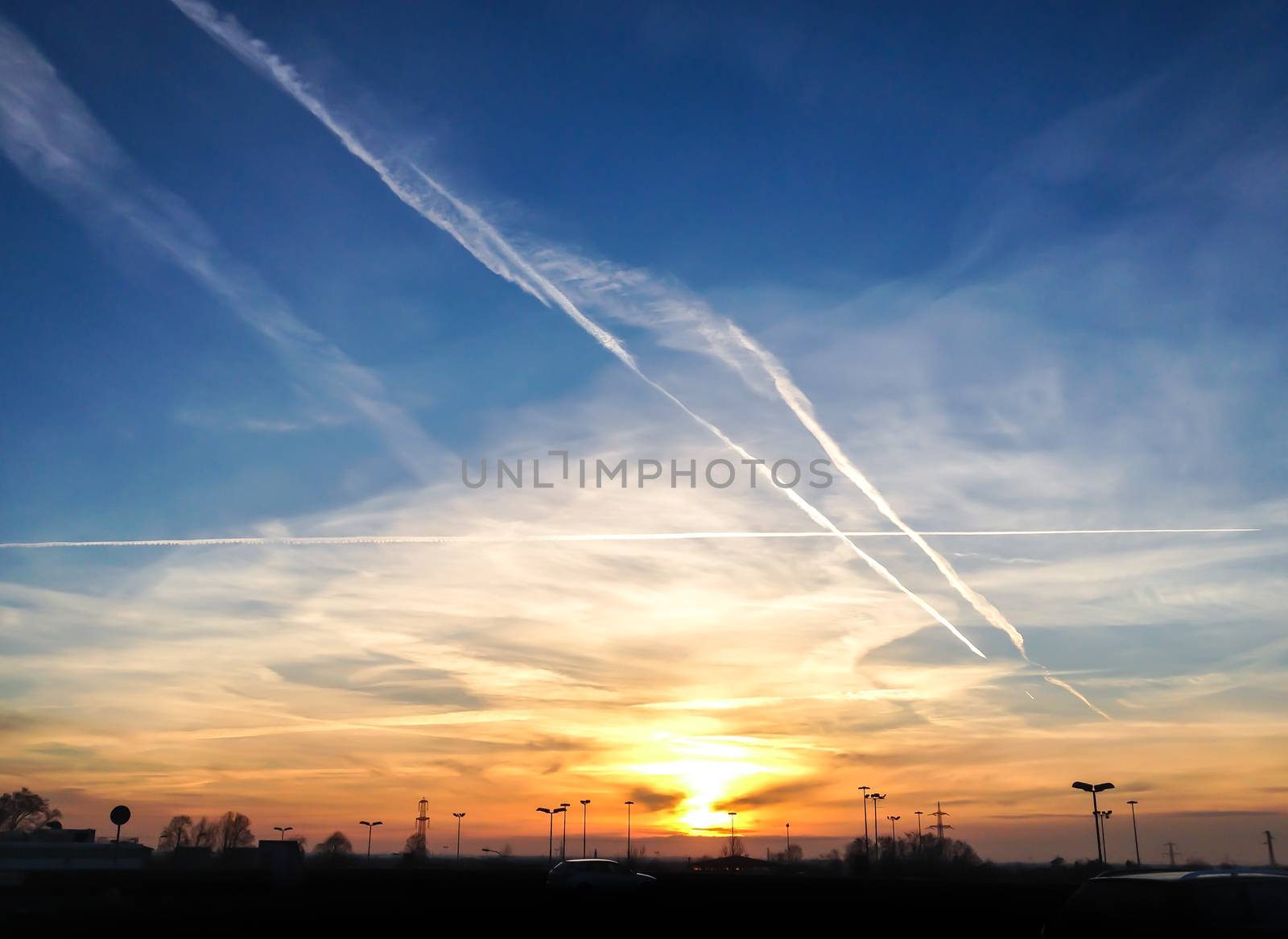 Dramatic sunset with contrails / chemtrails