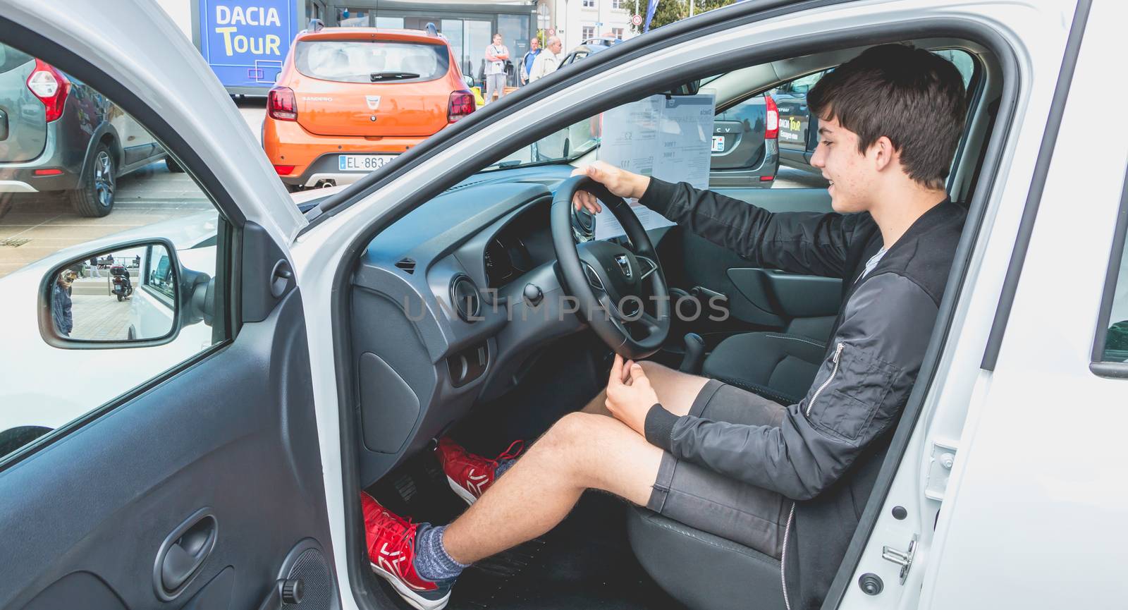 young man watching a car in Dacia Tour 2017 by AtlanticEUROSTOXX