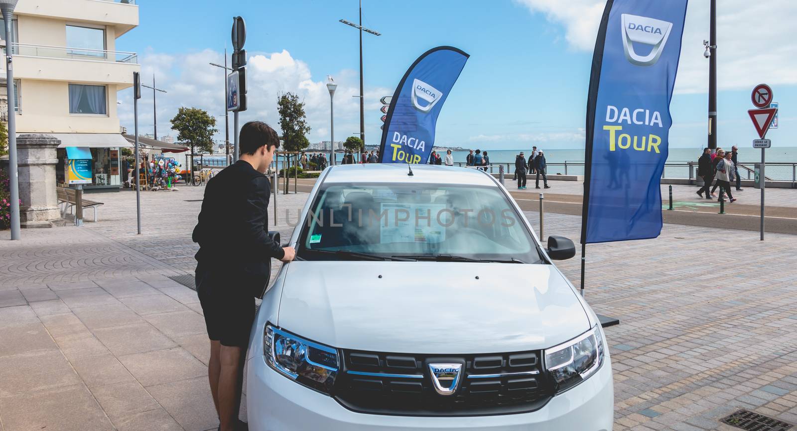 young man watching a car in Dacia Tour 2017 by AtlanticEUROSTOXX