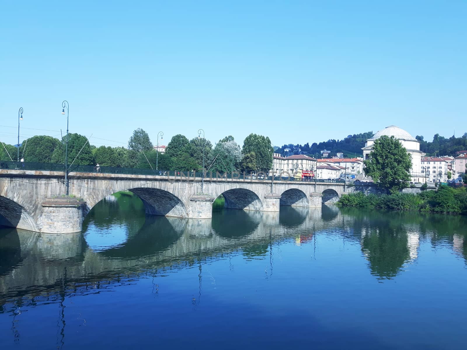 Turin, Italy - 06/06/2020: Beautiful panoramic view from Mole Antoneliana to the city of Turin in summer days with clear blue sky and the alps in the background.