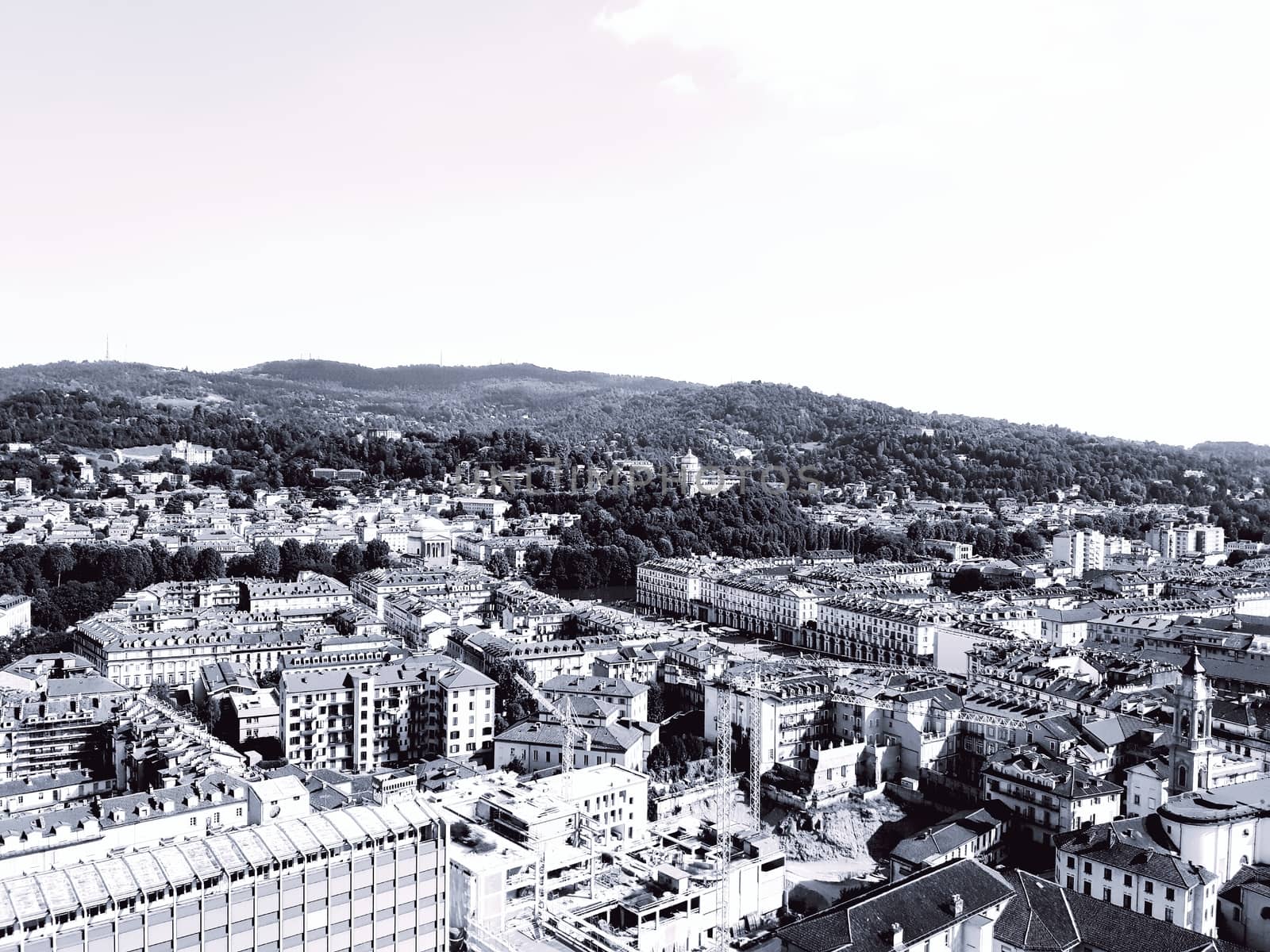 Turin, Italy - 06/06/2020: Beautiful panoramic view from Mole Antoneliana to the city of Turin in summer days with clear blue sky and the alps in the background.