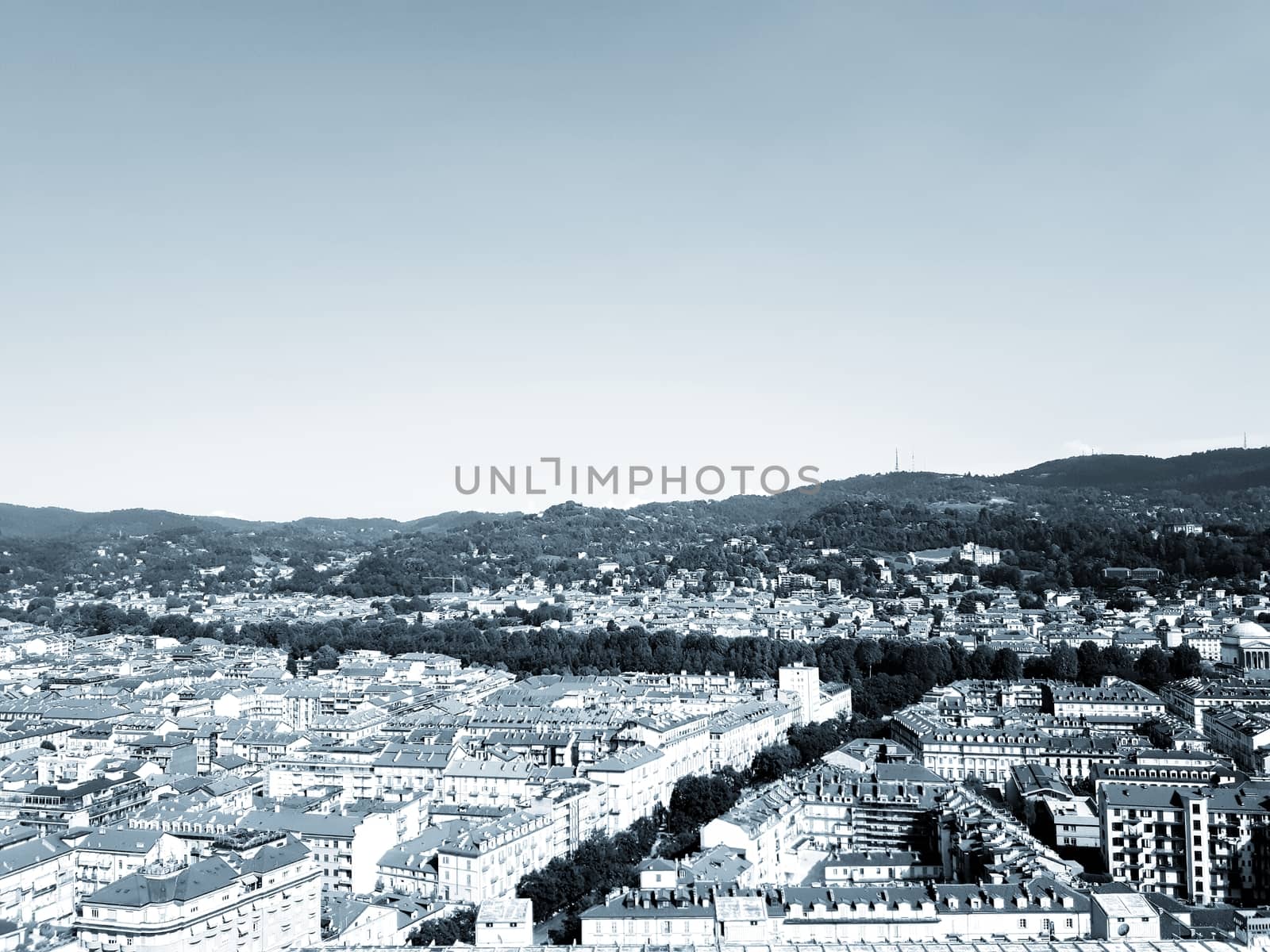 Turin, Italy - 06/06/2020: Beautiful panoramic view from Mole Antoneliana to the city of Turin in summer days with clear blue sky and the alps in the background.