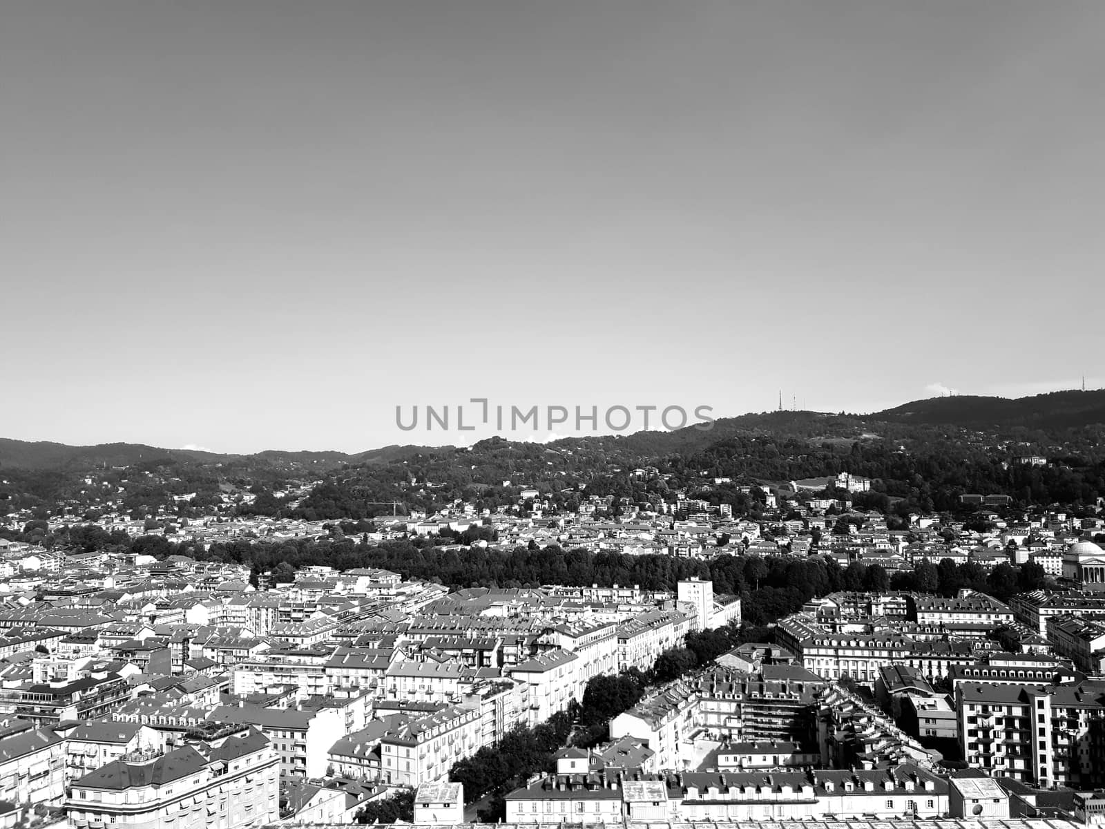 Turin, Italy - 06/06/2020: Beautiful panoramic view from Mole Antoneliana to the city of Turin in summer days with clear blue sky and the alps in the background.