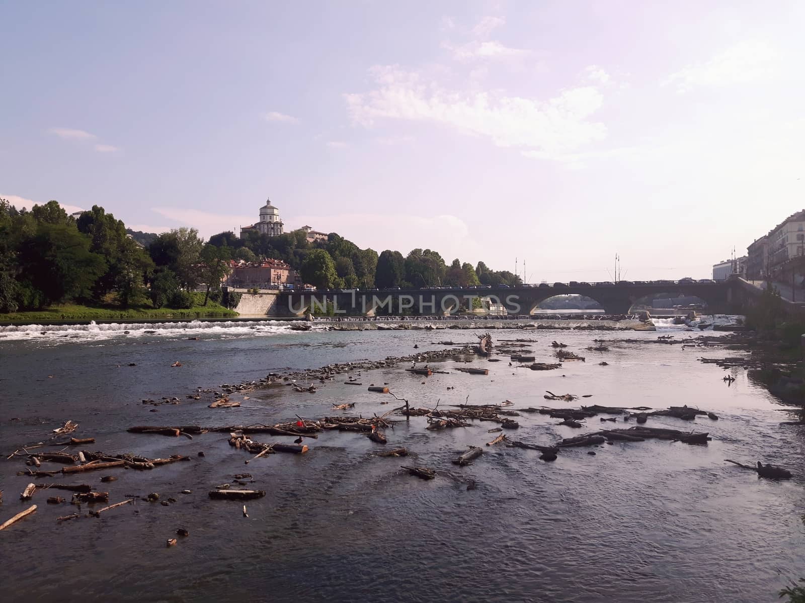 Turin, Italy - 06/06/2020: Beautiful panoramic view from Mole Antoneliana to the city of Turin in summer days with clear blue sky and the alps in the background.