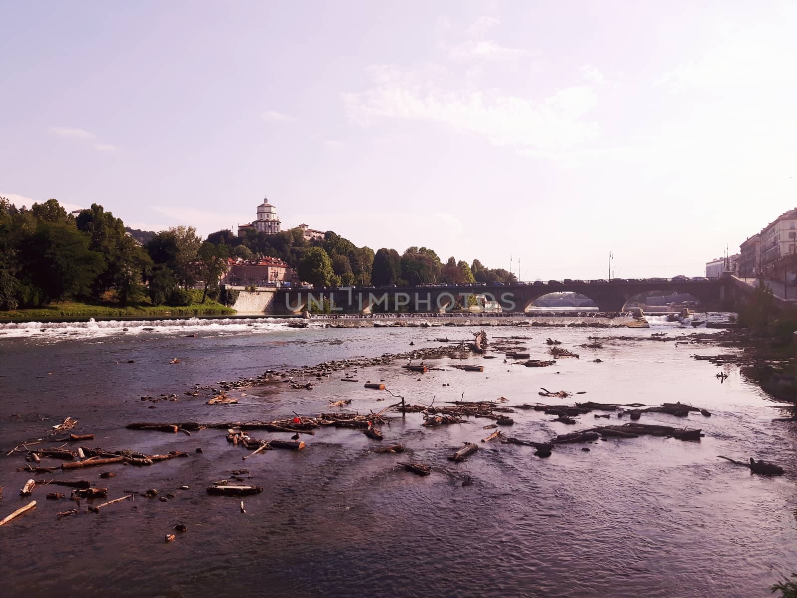 Turin, Italy - 06/06/2020: Beautiful panoramic view from Mole Antoneliana to the city of Turin in summer days with clear blue sky and the alps in the background.