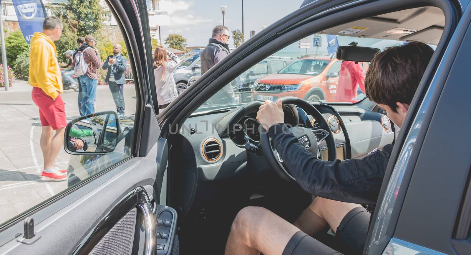 young man watching a car in Dacia Tour 2017 by AtlanticEUROSTOXX