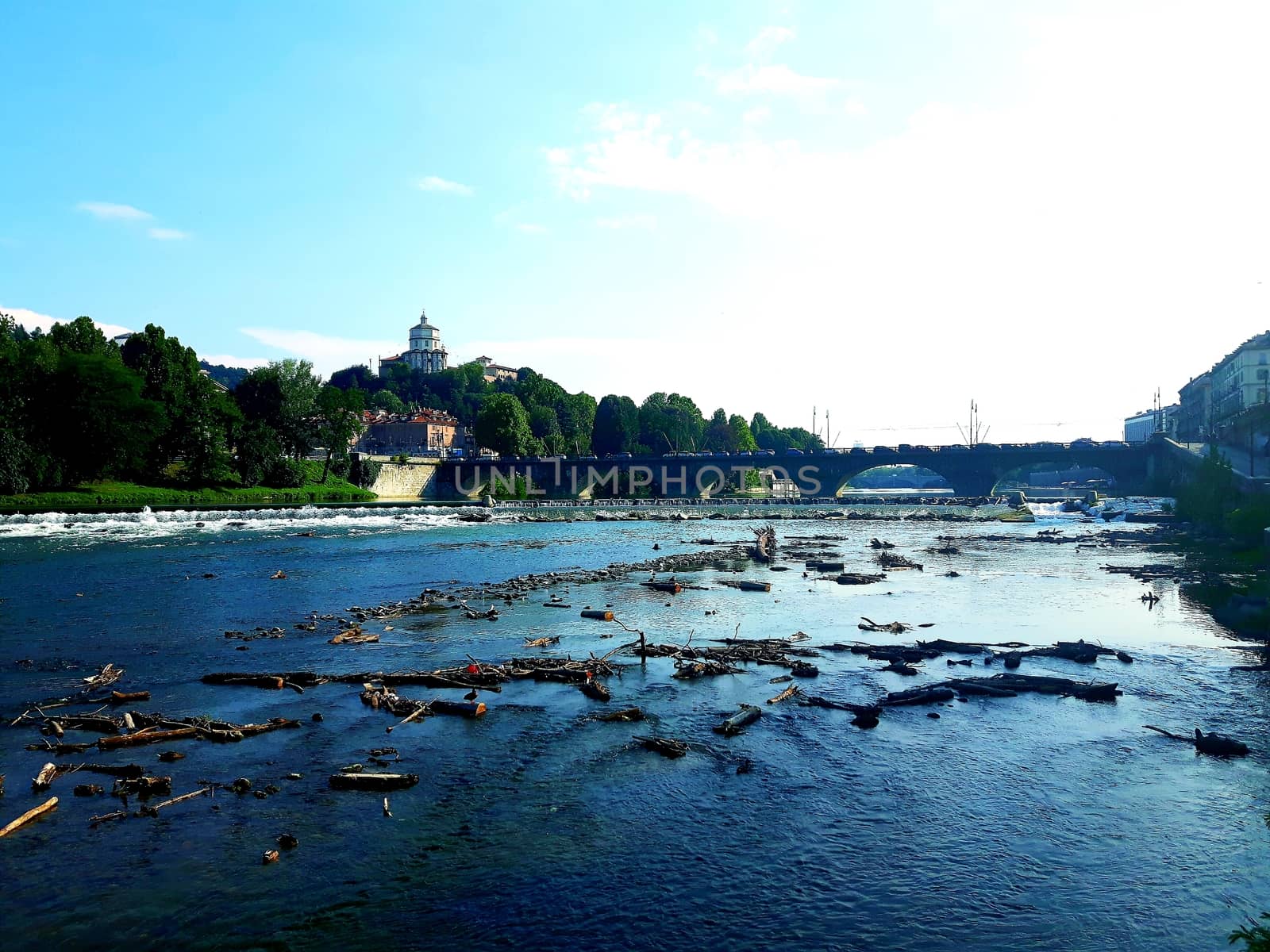 Turin, Italy - 06/06/2020: Beautiful panoramic view from Mole Antoneliana to the city of Turin in summer days with clear blue sky and the alps in the background.