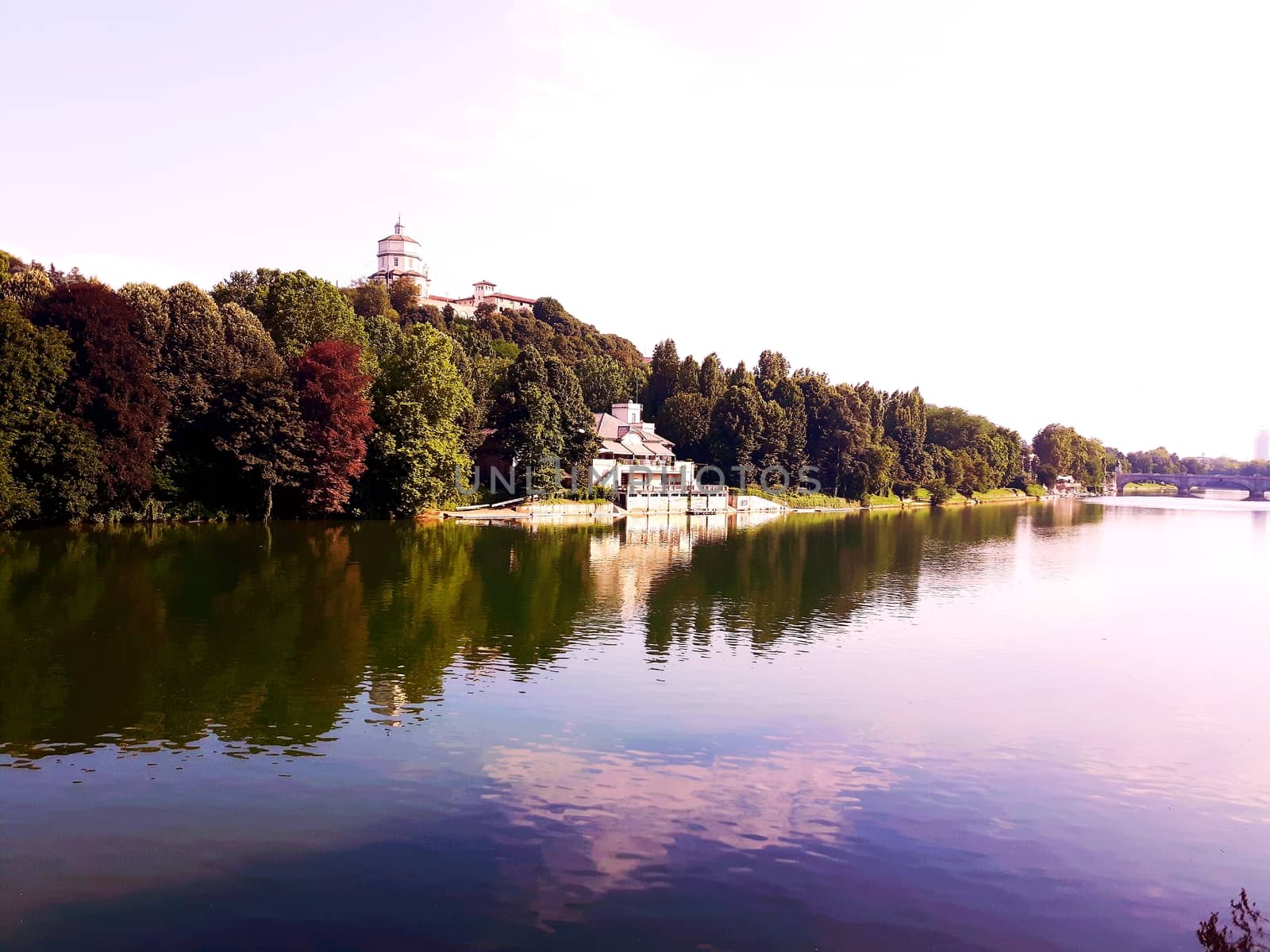 Turin, Italy - 06/06/2020: Beautiful panoramic view from Mole Antoneliana to the city of Turin in summer days with clear blue sky and the alps in the background.