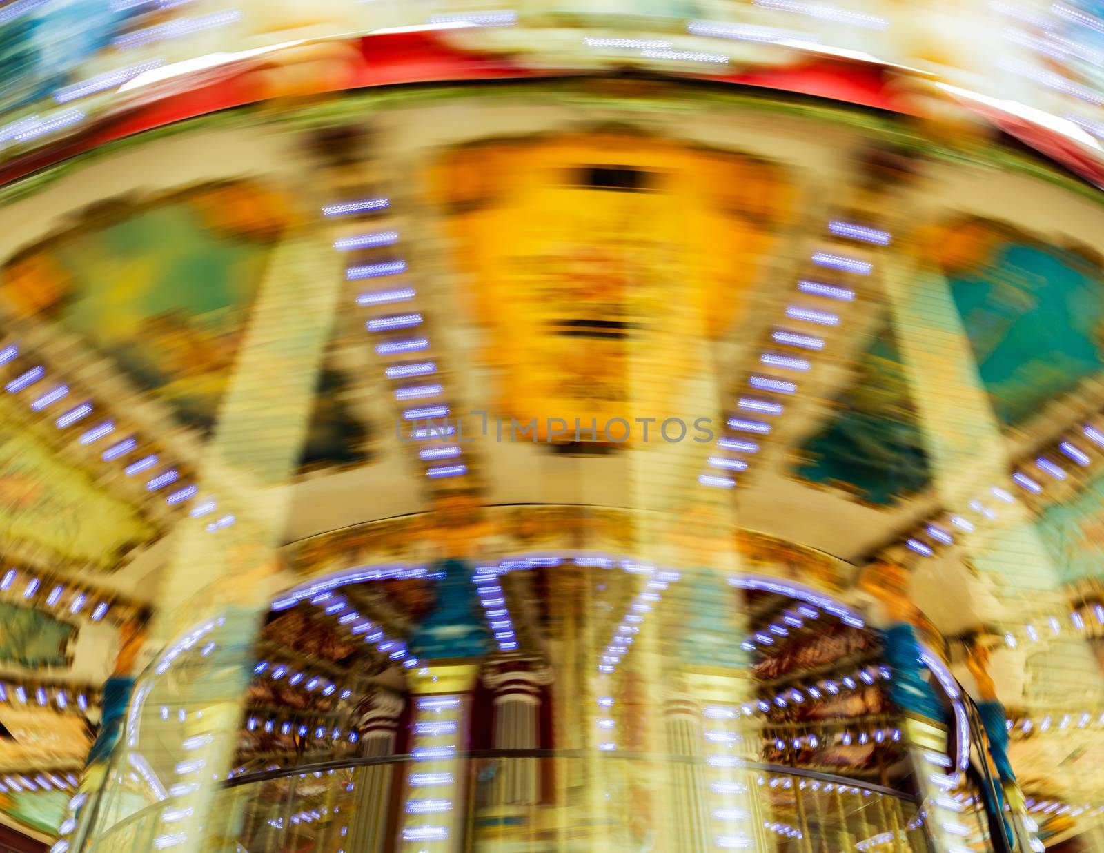 Vintage traditional carousel spinning, with motion blur