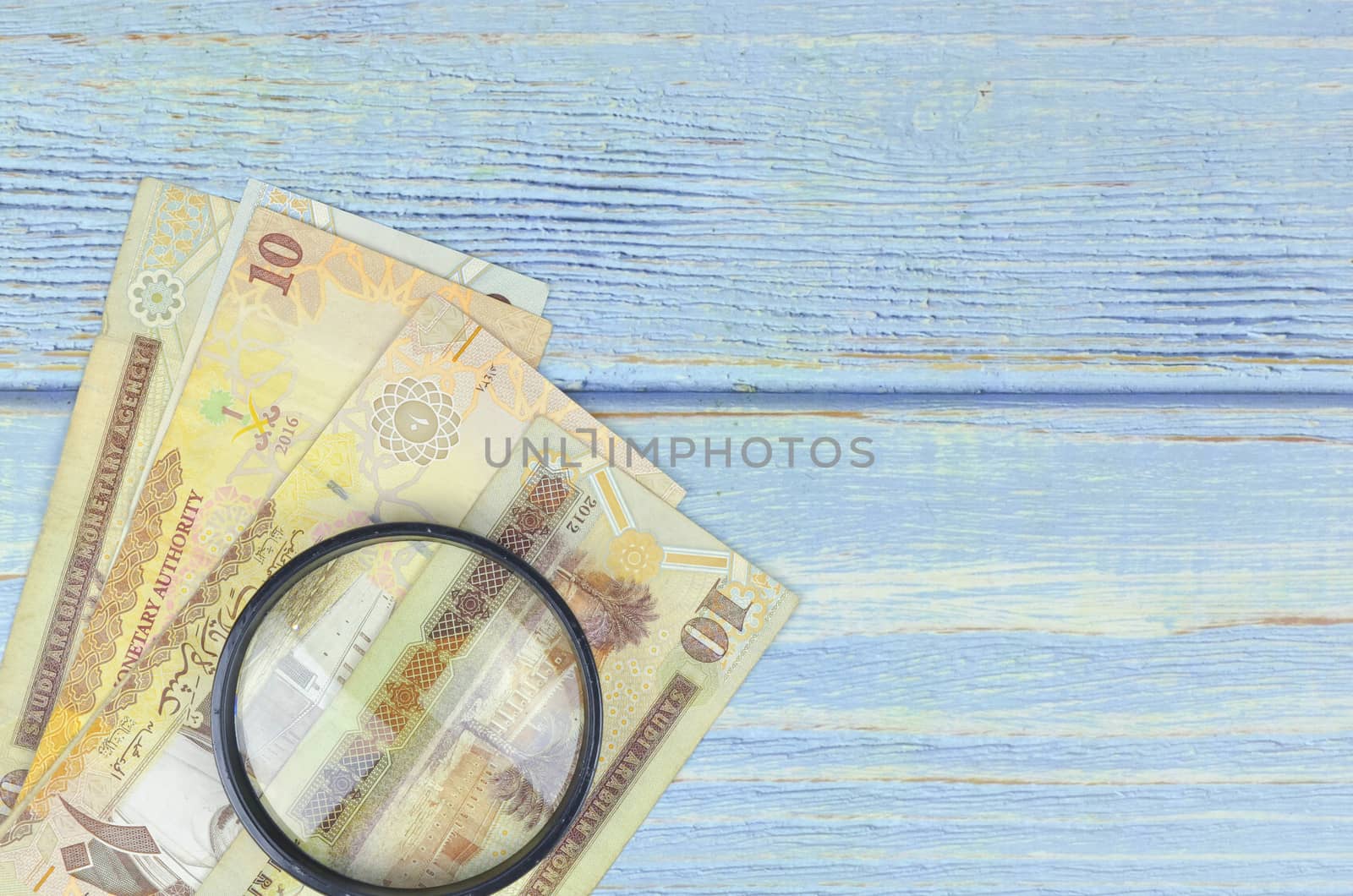 Saudi Arabia money on wooden background.