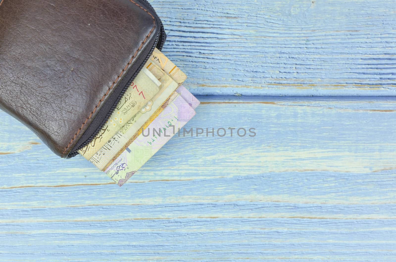 Saudi Arabia money on wooden background.