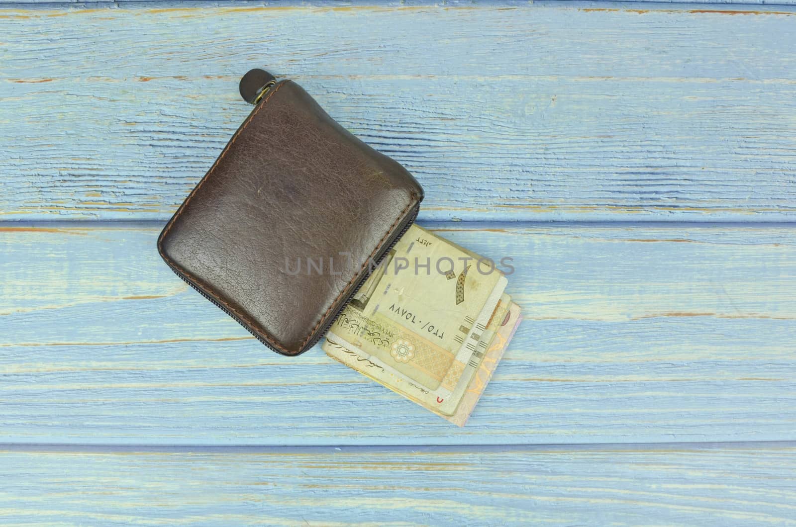 Saudi Arabia money on wooden background.