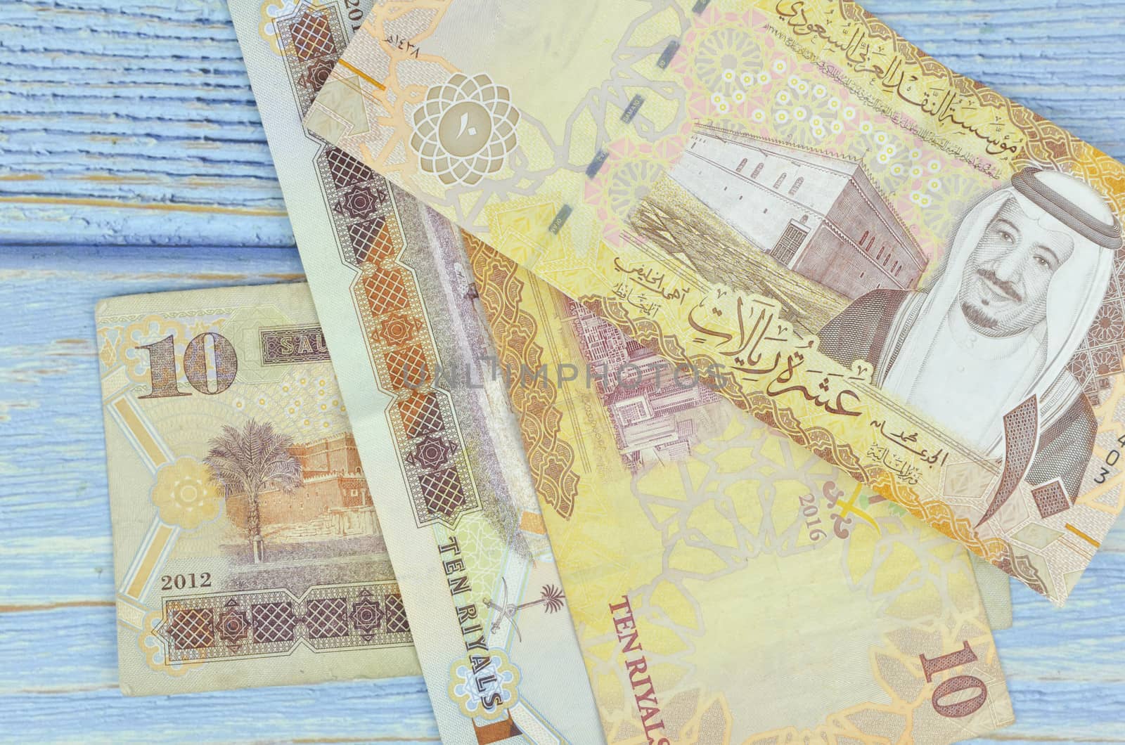 Saudi Arabia money on wooden background.