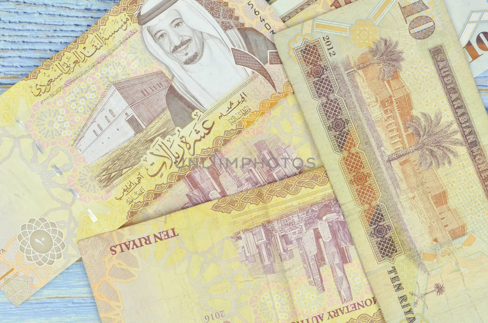 Saudi Arabia money on wooden background.