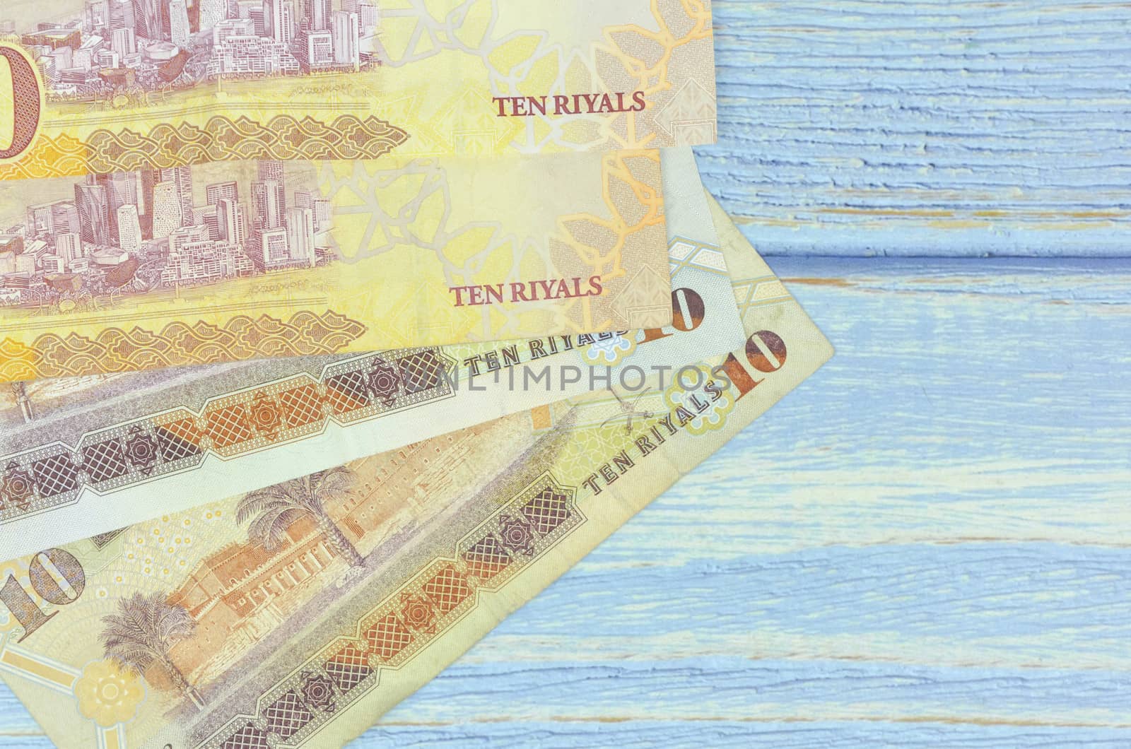 Saudi Arabia money on wooden background.