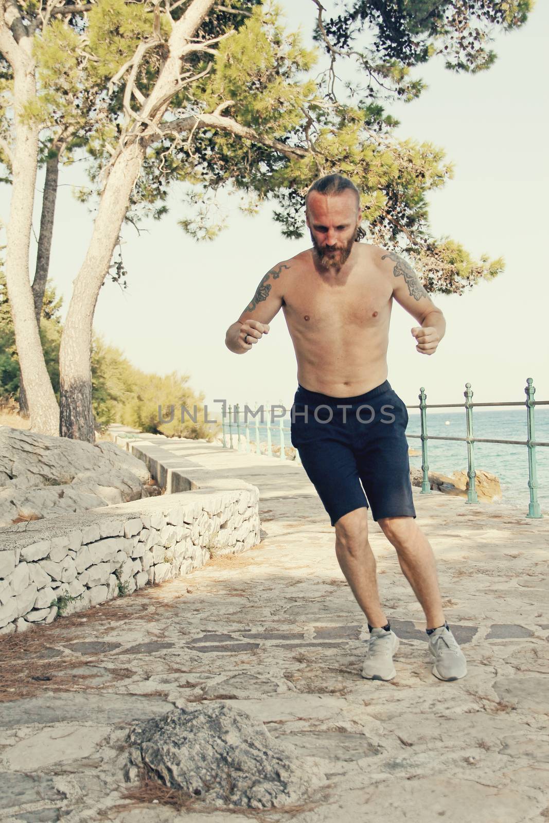 A shot of a sport mid adult man jumping outdoors