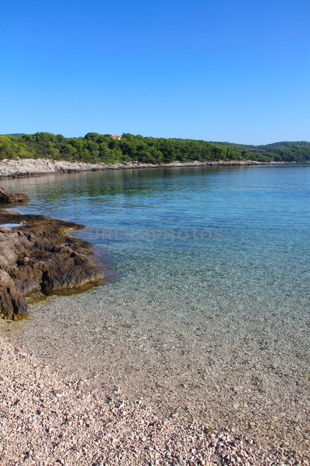 Turquoise sea water white stone beach and mountains, Sumartin, Brac island, Croatia