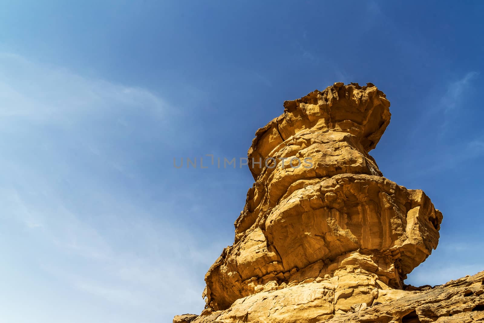 Impressive solitary rock with Eolian erosion marks in the desert of Wadi Rum, Jordan, middle east