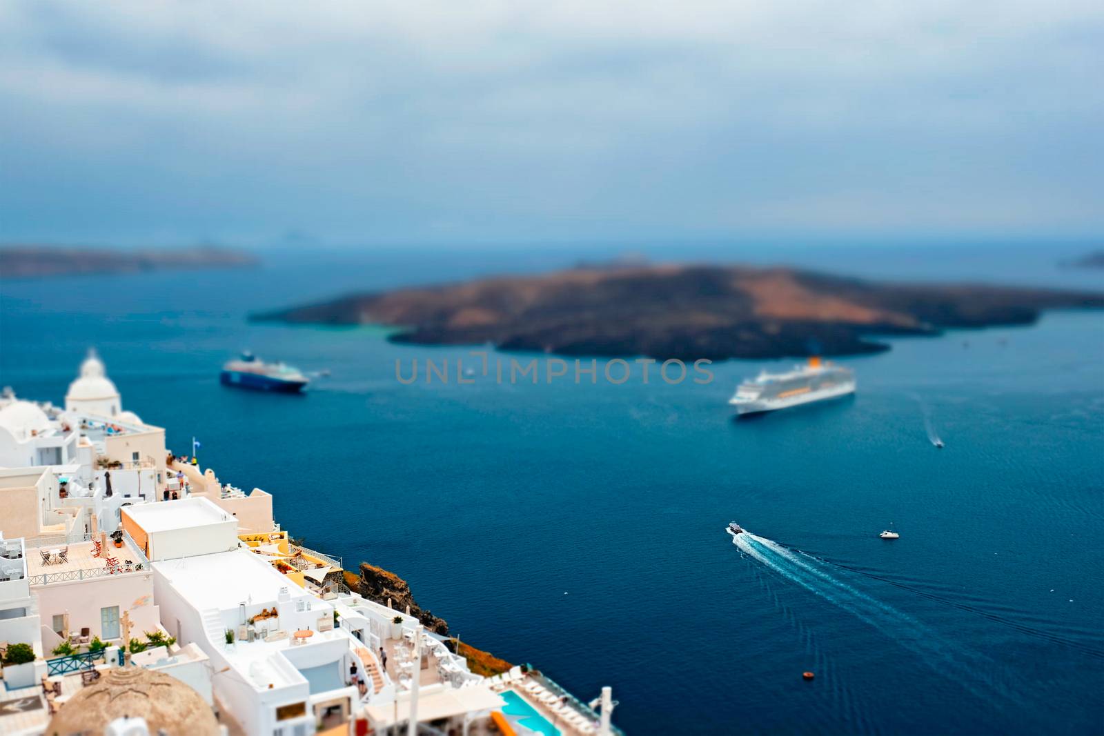 View of Fira town on Santorini island with cruise ships in sea by dimol