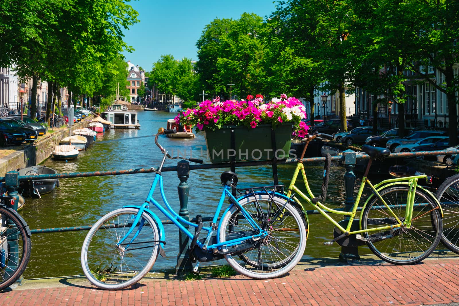 Amsterdam canal with boats and bicycles on a bridge by dimol