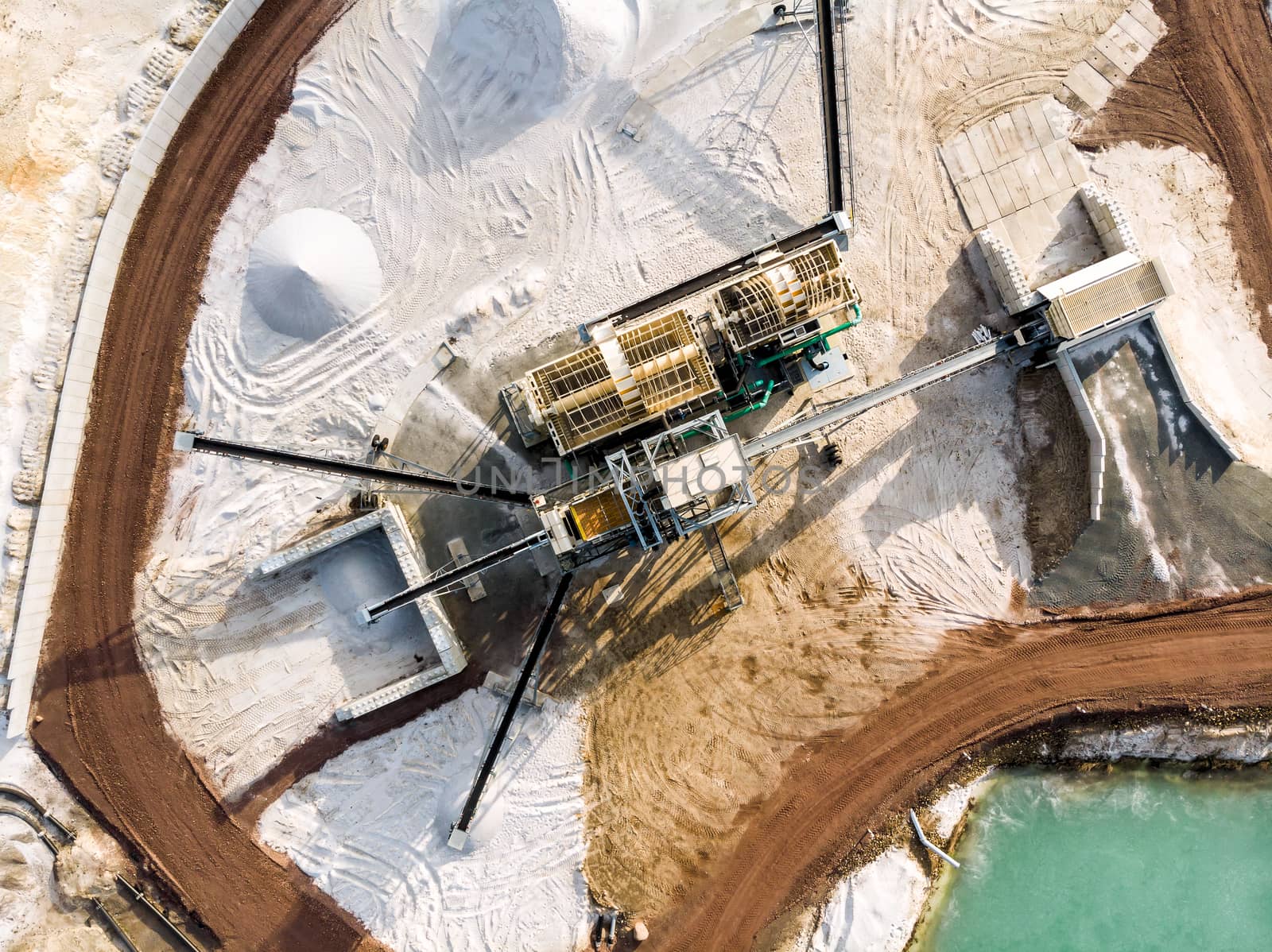 Aerial view of the processing plant with the sand fractionator at the edge of a quartz sand quarry pond for white quartz sand by geogif