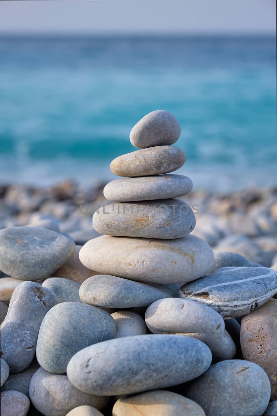 Zen balanced stones stack on beach by dimol
