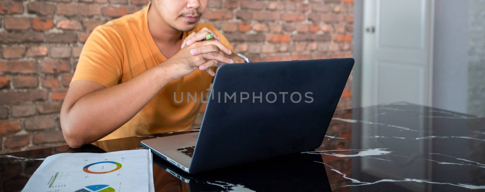 Asian man uses a notebook computer and works hard and meeting at home and he is stressed and Headache. by Tuiphotoengineer