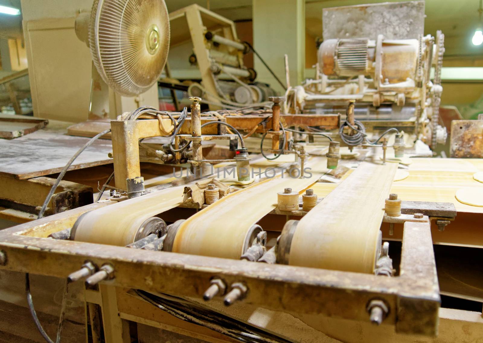 Old machine for the automatic production of Arab flatbread in the largest bread bakery of Akaba, Jordan, middle east