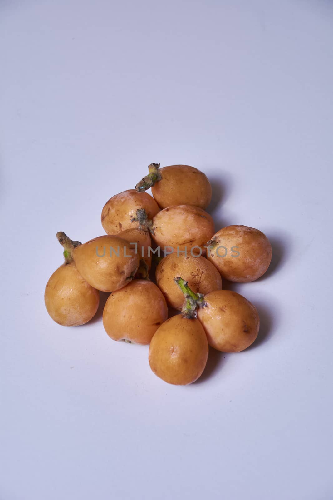 Set of medlars in order on white table, natural, ecological, without retouching