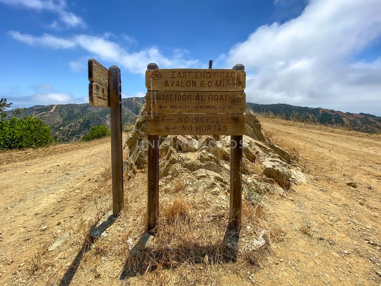 Wooden sign board with direction on the hiking trails on the top of Santa Catalina Island mountains by Bonandbon